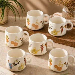 Cute pastel ceramic cups with nature design, aesthetic kitchen setup