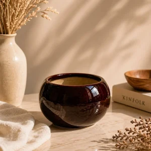 Teal glossy ceramic planter pot on marble table with aesthetic modern home decor styling