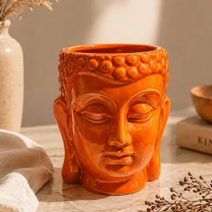 Brown ceramic face planter pot with sculptural design on marble surface aesthetic home decor