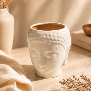 Ivory textured ceramic face planter pot with speckled finish on wooden table aesthetic home decor