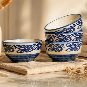 Set of 4 blue and white ceramic bowls with floral pattern on wooden table aesthetic kitchenware